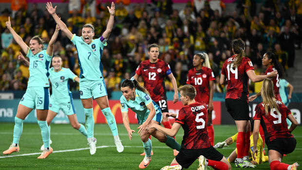 Australia celebrating a goal against Canada.